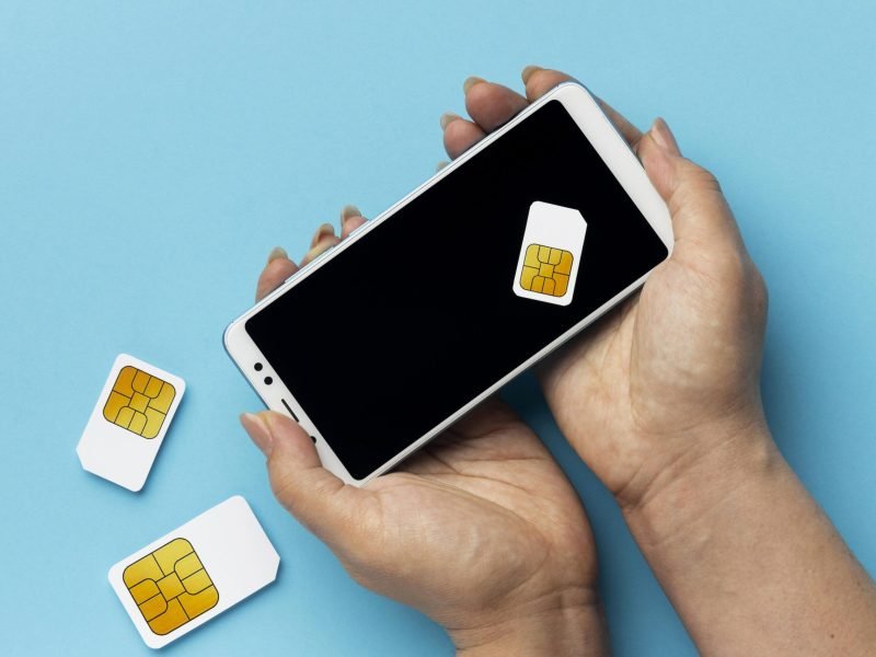 front-view-hands-holding-smartphone-sim-cards